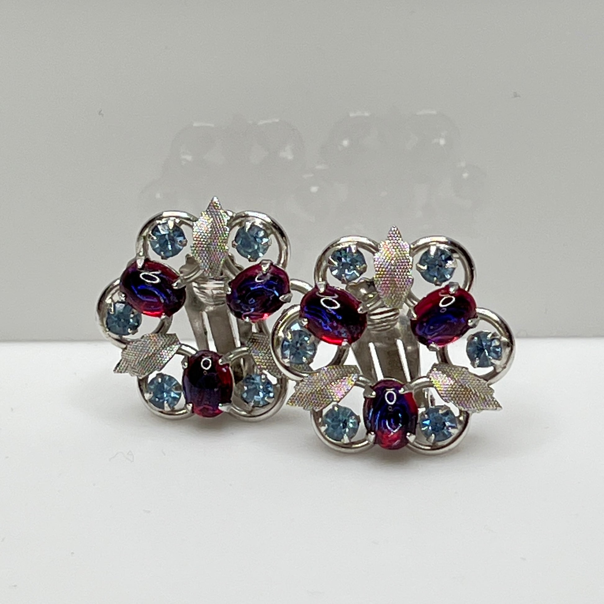 1950s floral earrings with prong-set stones and silver-tone leaf accents