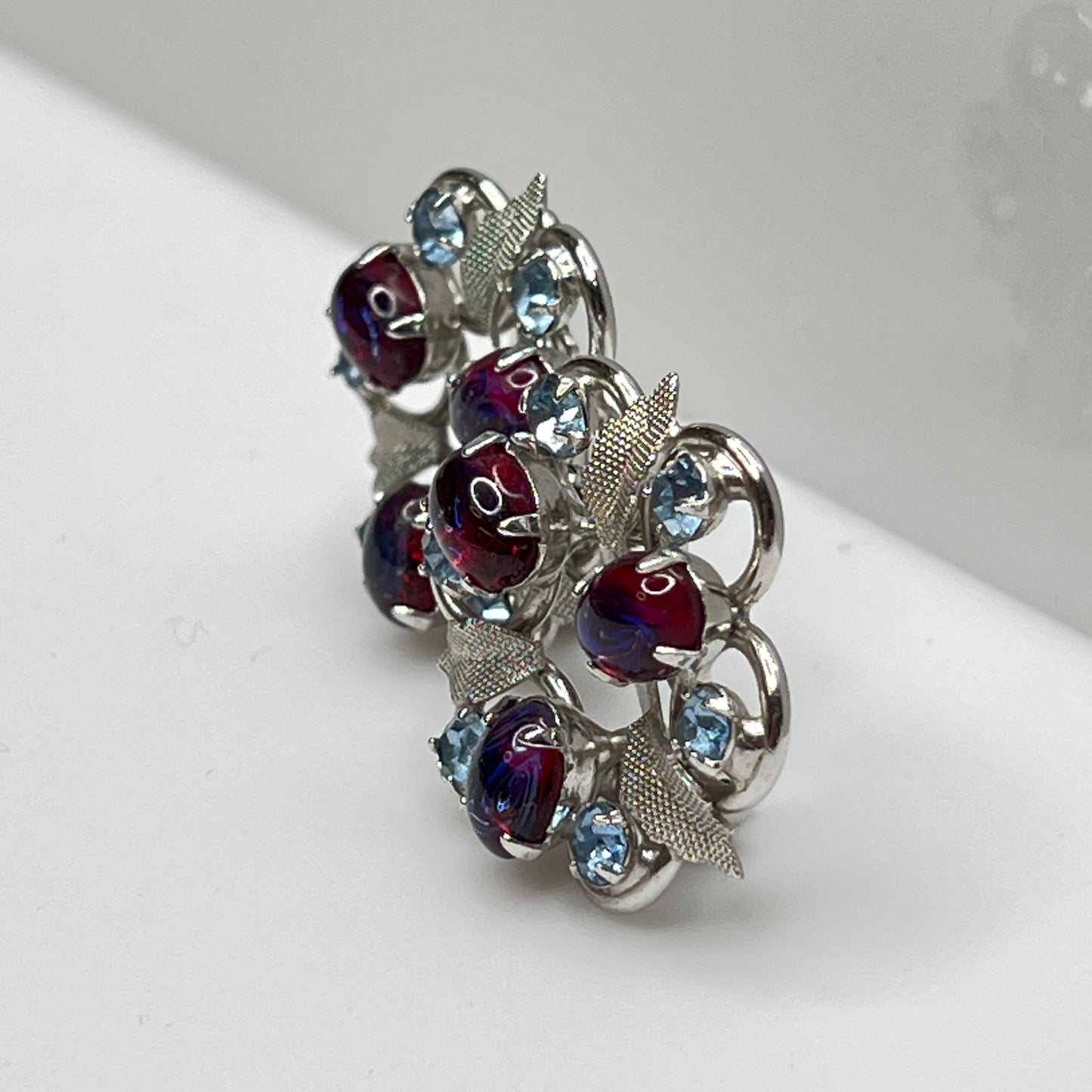 Close-up of vintage red and blue glass rhinestone earrings