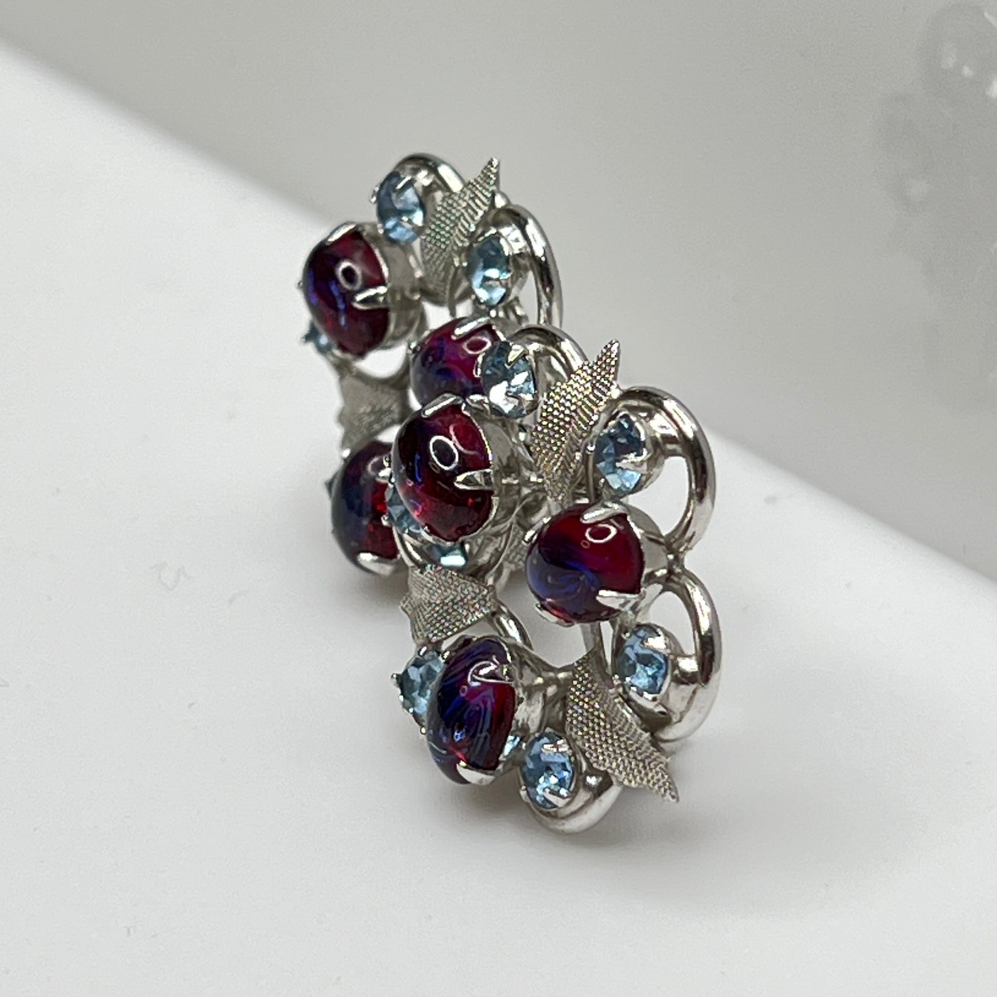 Close-up of vintage red and blue glass rhinestone earrings
