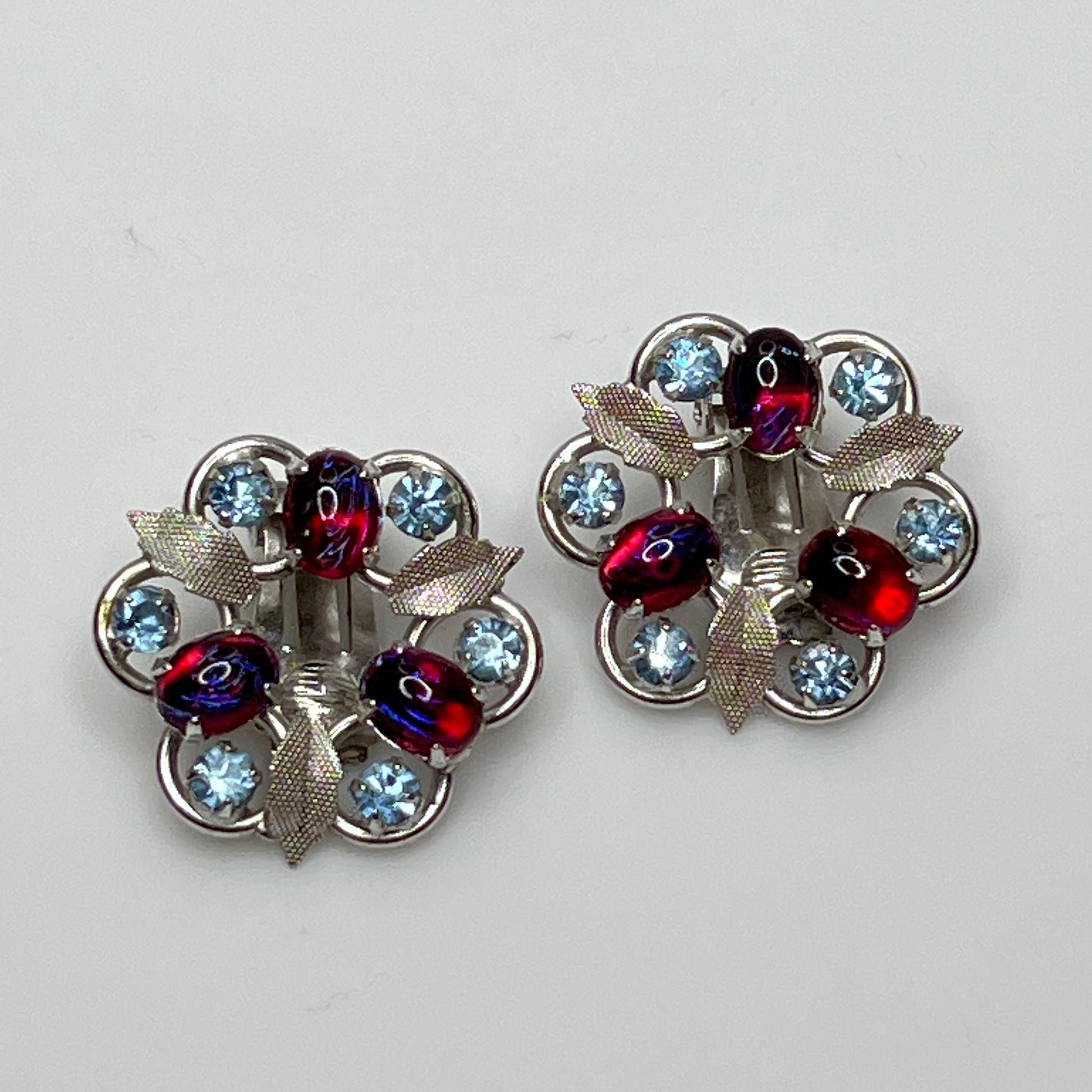 Close-up of vintage red and blue glass rhinestone earrings