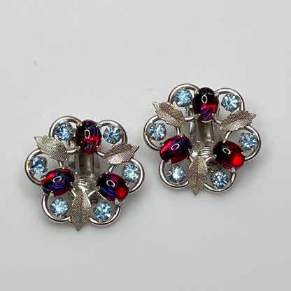 Close-up of vintage red and blue glass rhinestone earrings