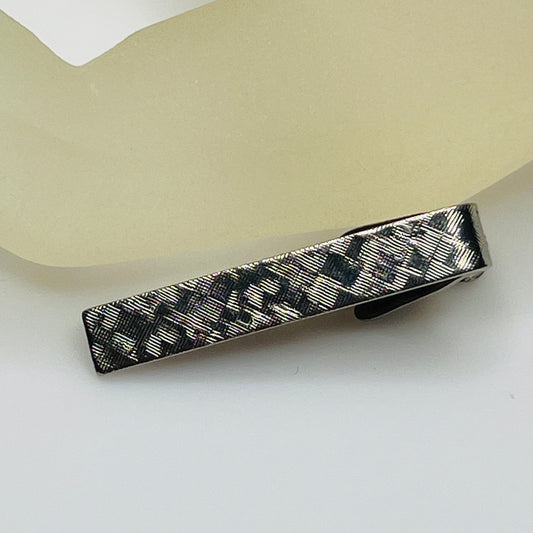 Vintage silver tie clip with crosshatch textured finish, shown front view