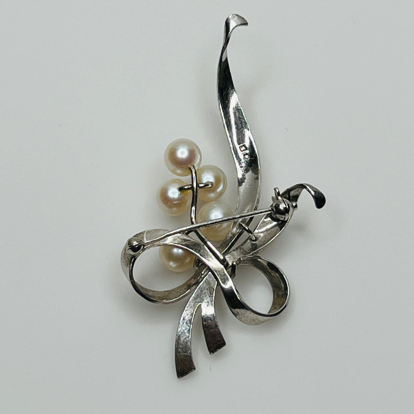 Reverse view of brooch signed Mikimoto