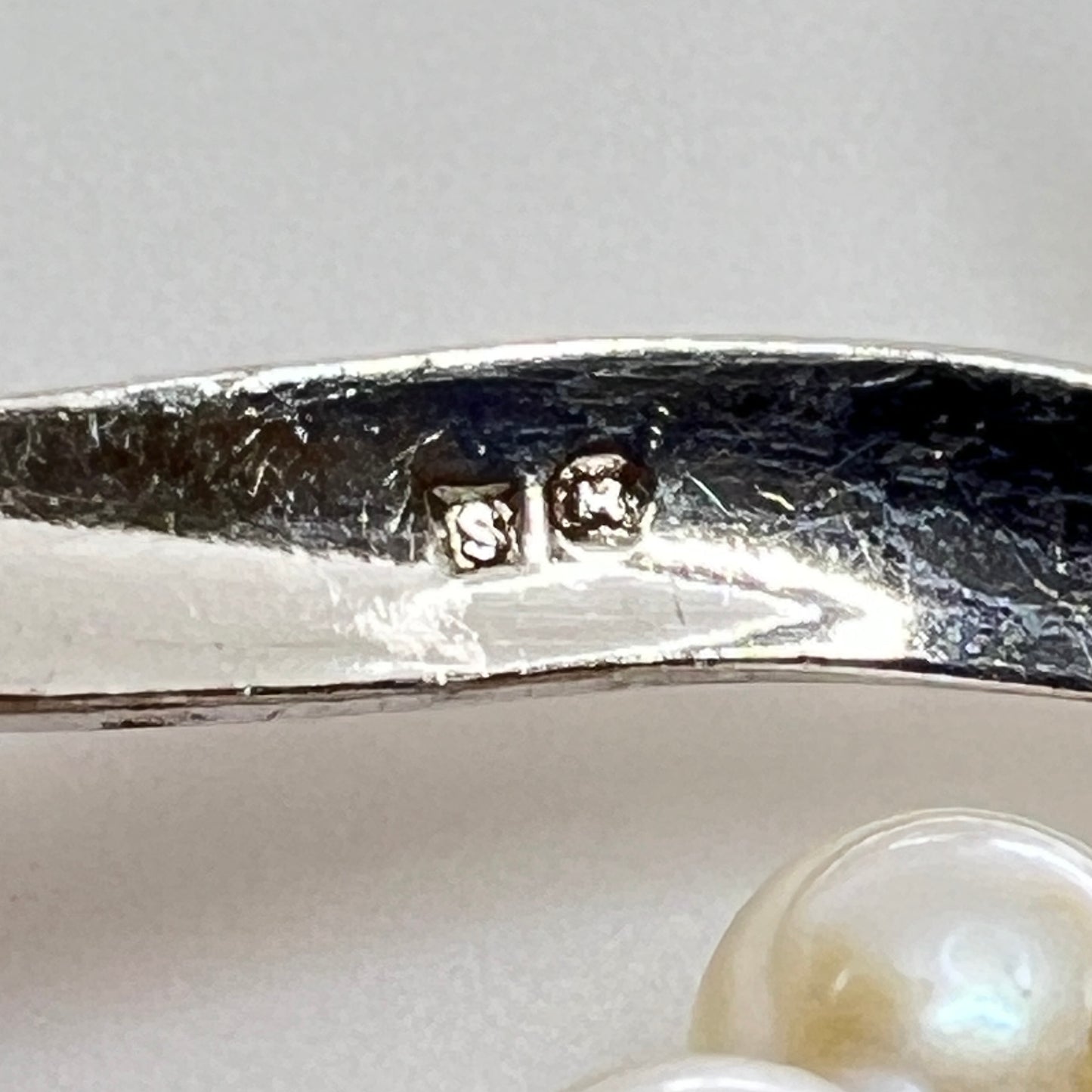 Reverse view of brooch signed Mikimoto