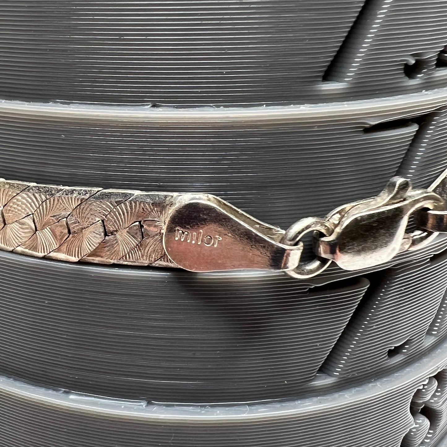 Close-up of clasp stamped “Milor” on sterling silver Italian bracelet