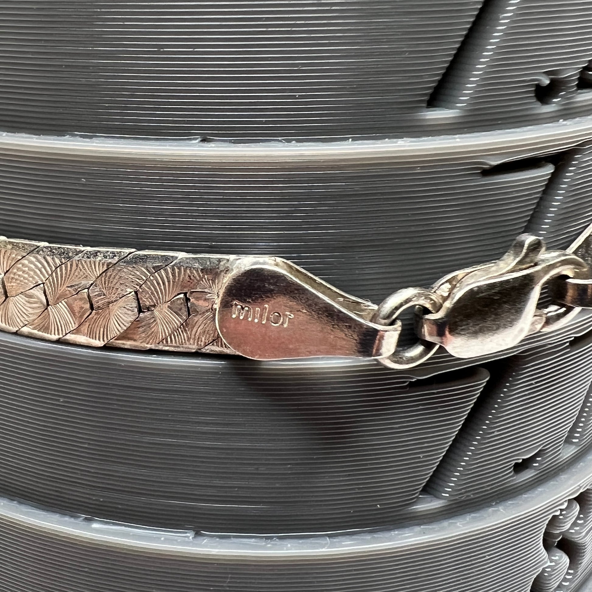 Close-up of clasp stamped “Milor” on sterling silver Italian bracelet