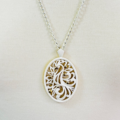 White enamel Monet jewelry set with bird of paradise motif 