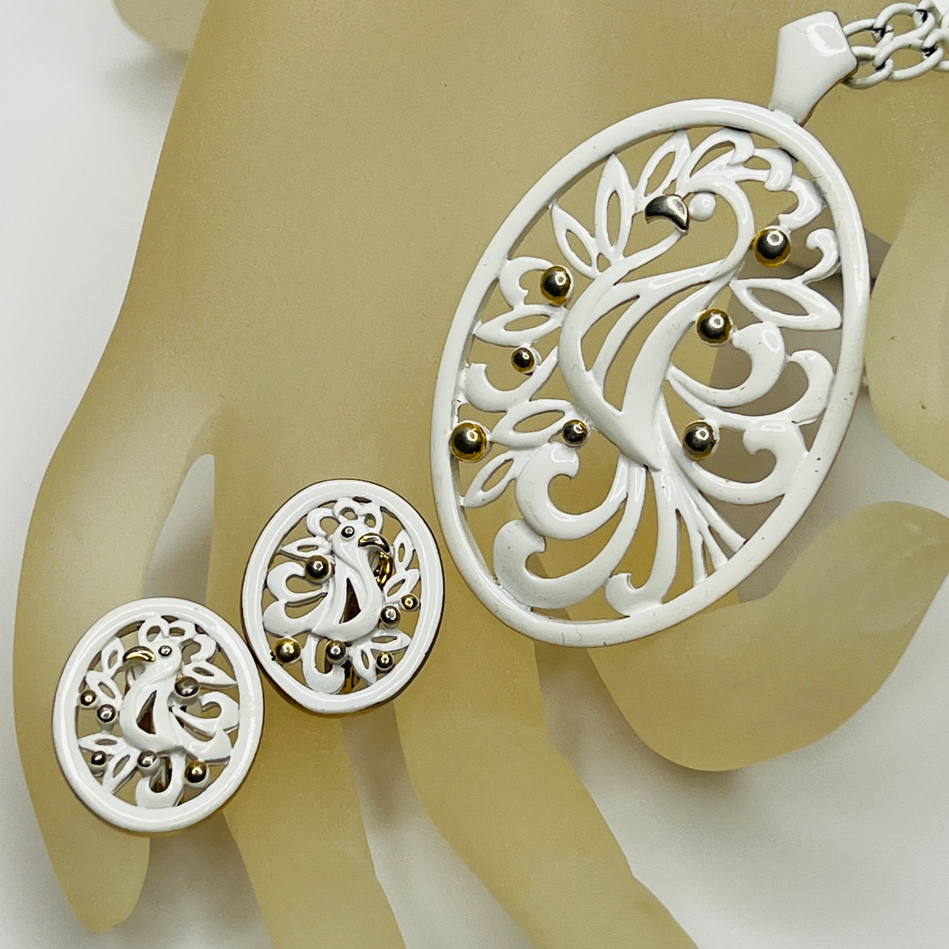 White enamel Monet jewelry set with bird of paradise motif pendant and matching clip-on earrings