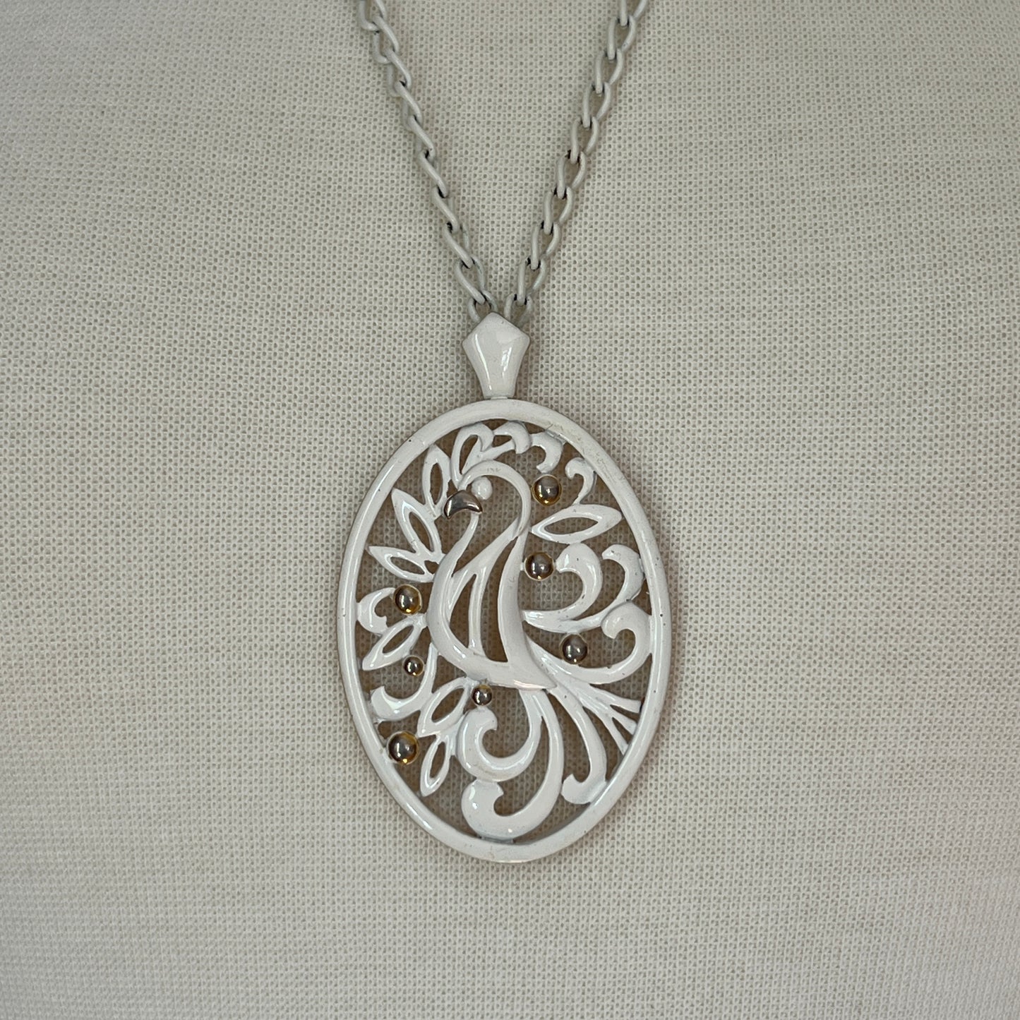 White enamel Monet jewelry set with bird of paradise motif pendant and matching clip-on earrings