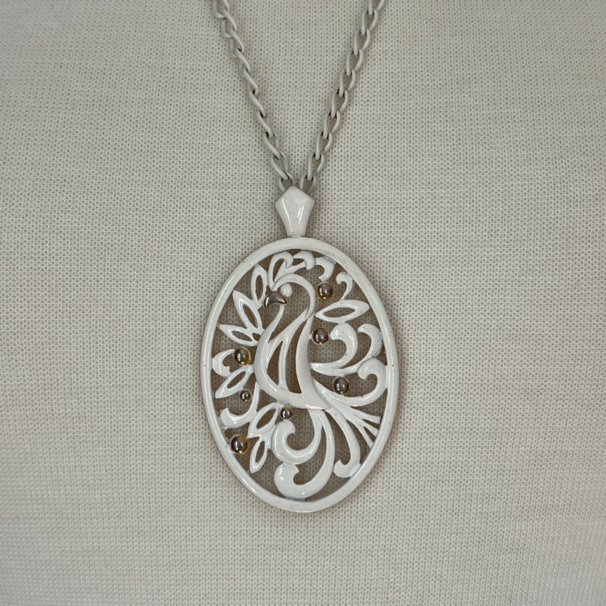 White enamel Monet jewelry set with bird of paradise motif pendant and matching clip-on earrings