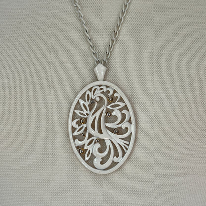 White enamel Monet jewelry set with bird of paradise motif pendant and matching clip-on earrings