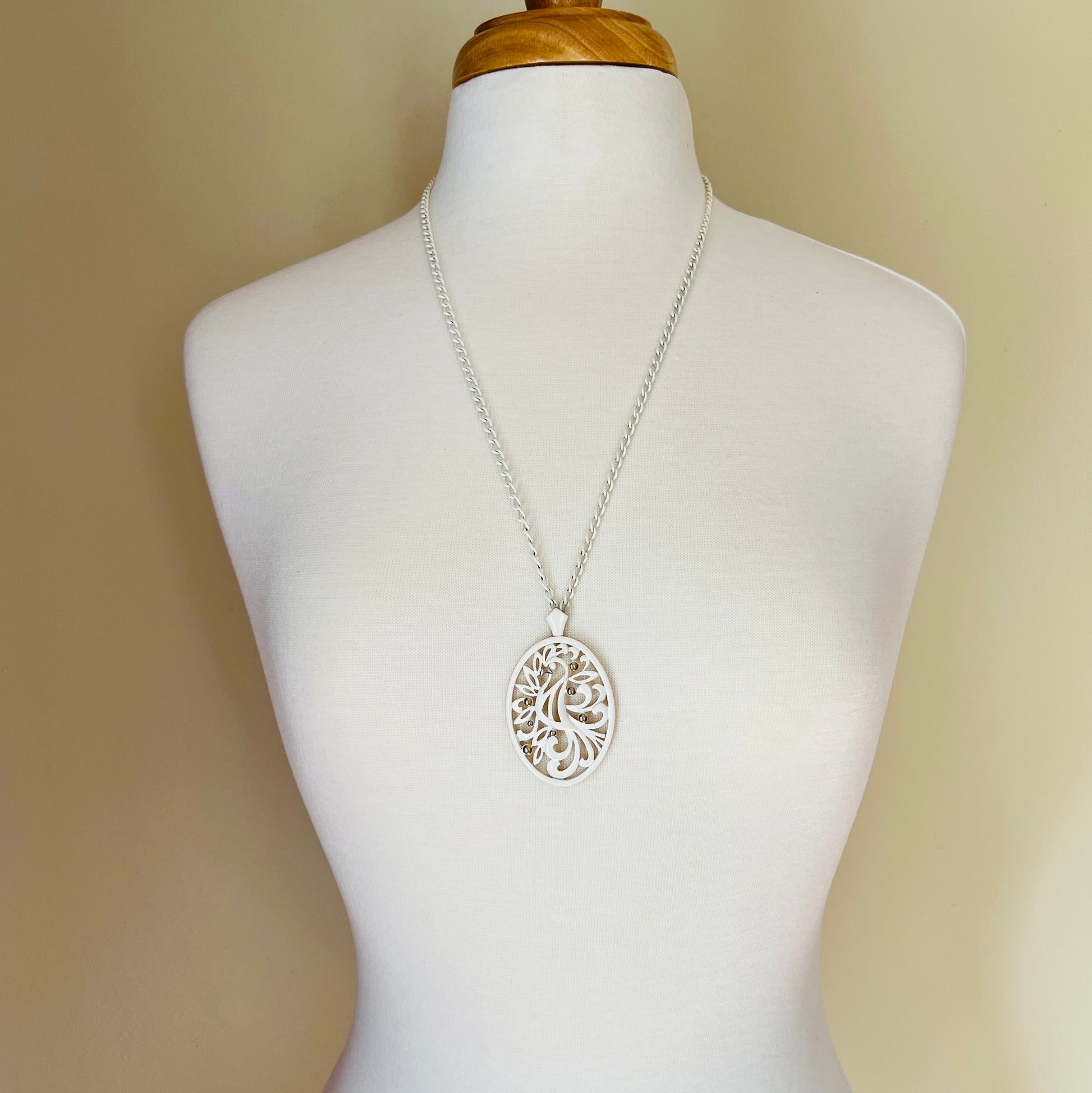 White enamel Monet jewelry set with bird of paradise motif pendant and matching clip-on earrings