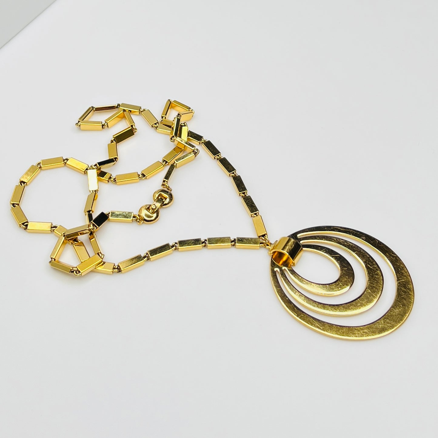 1980s Monet signed goldtone necklace with geometric pendant and rectangular chain