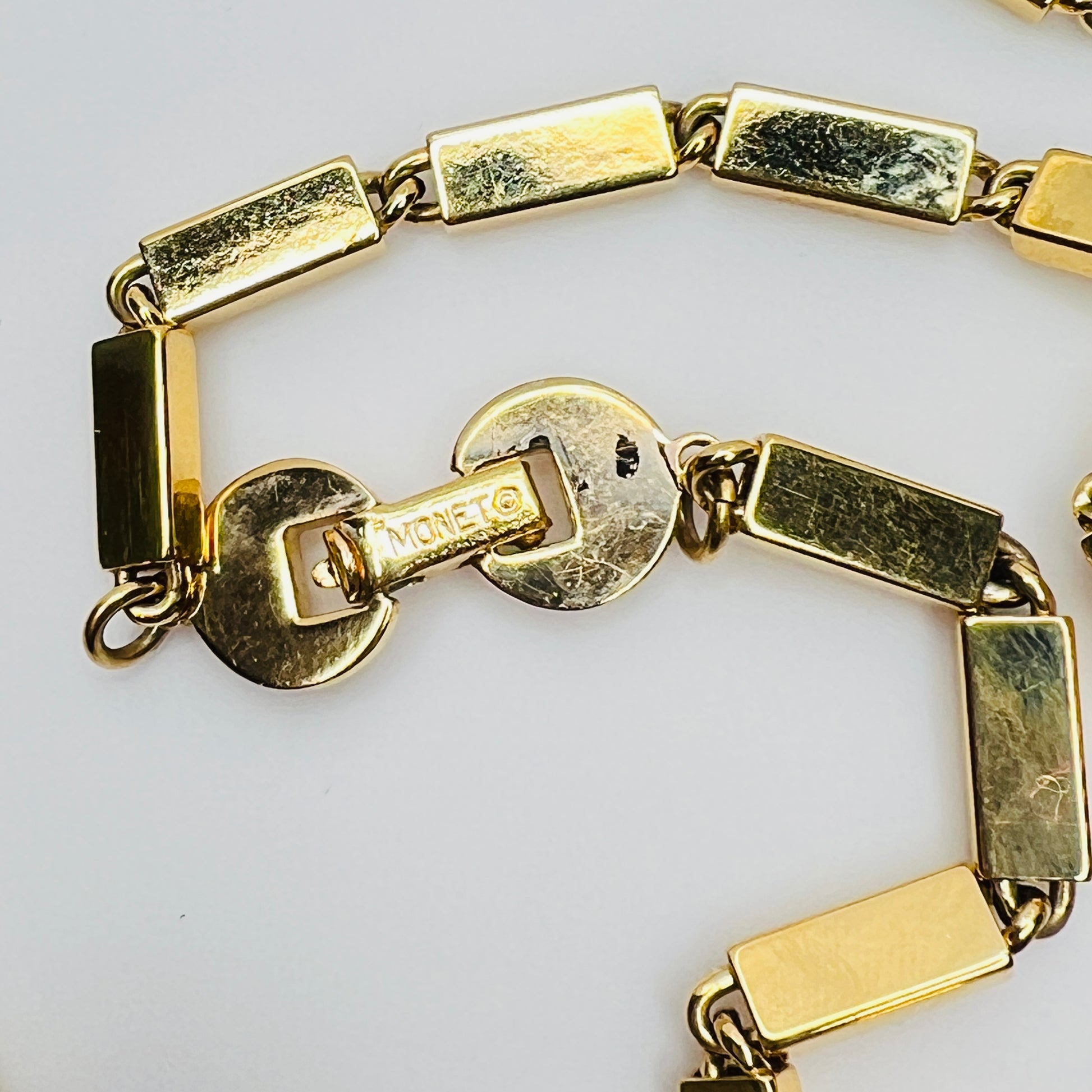 Close-up of signed Monet clasp on vintage 1980s goldtone necklace