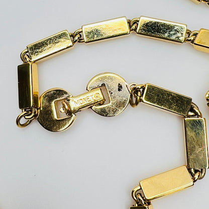 Close-up of signed Monet clasp on vintage 1980s goldtone necklace