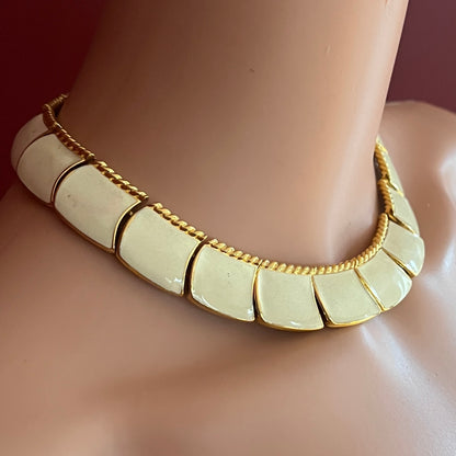 Close-up of enamel and gold tone links with rope detailing