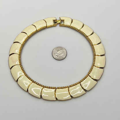 Close-up of enamel and gold tone links with rope detailing