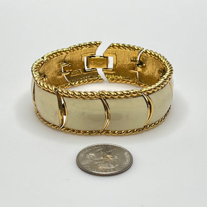 Close-up of enamel and gold tone links with rope detailing