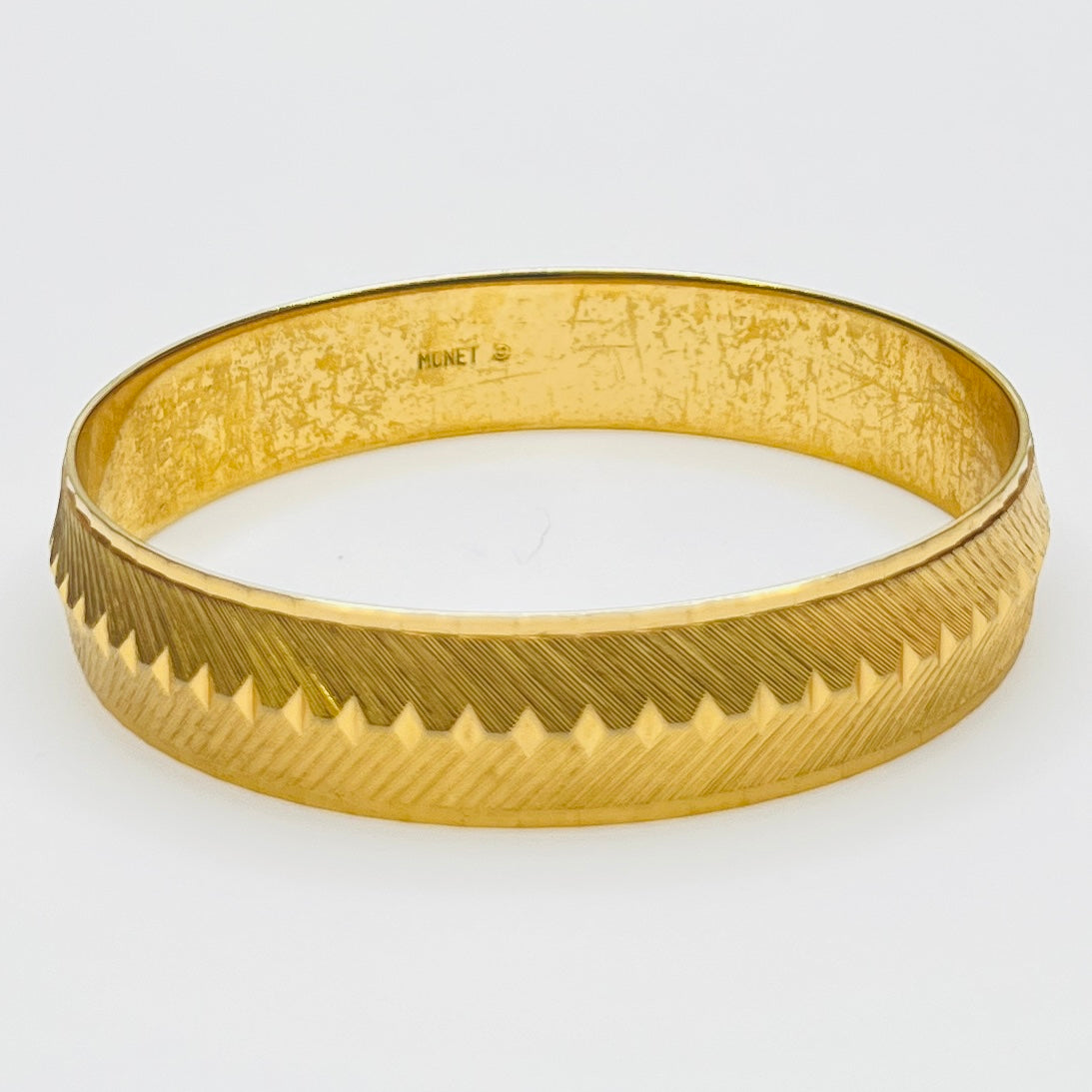 Signed Monet gold tone etched bangle bracelet