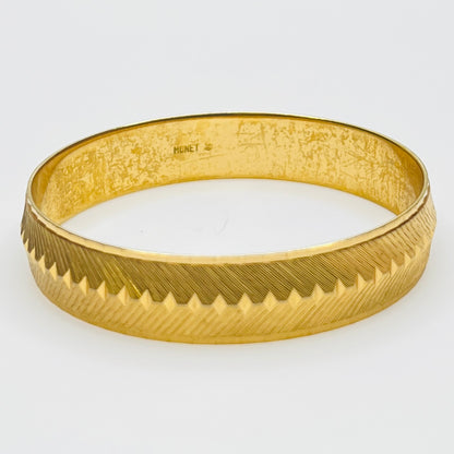 Signed Monet gold tone etched bangle bracelet