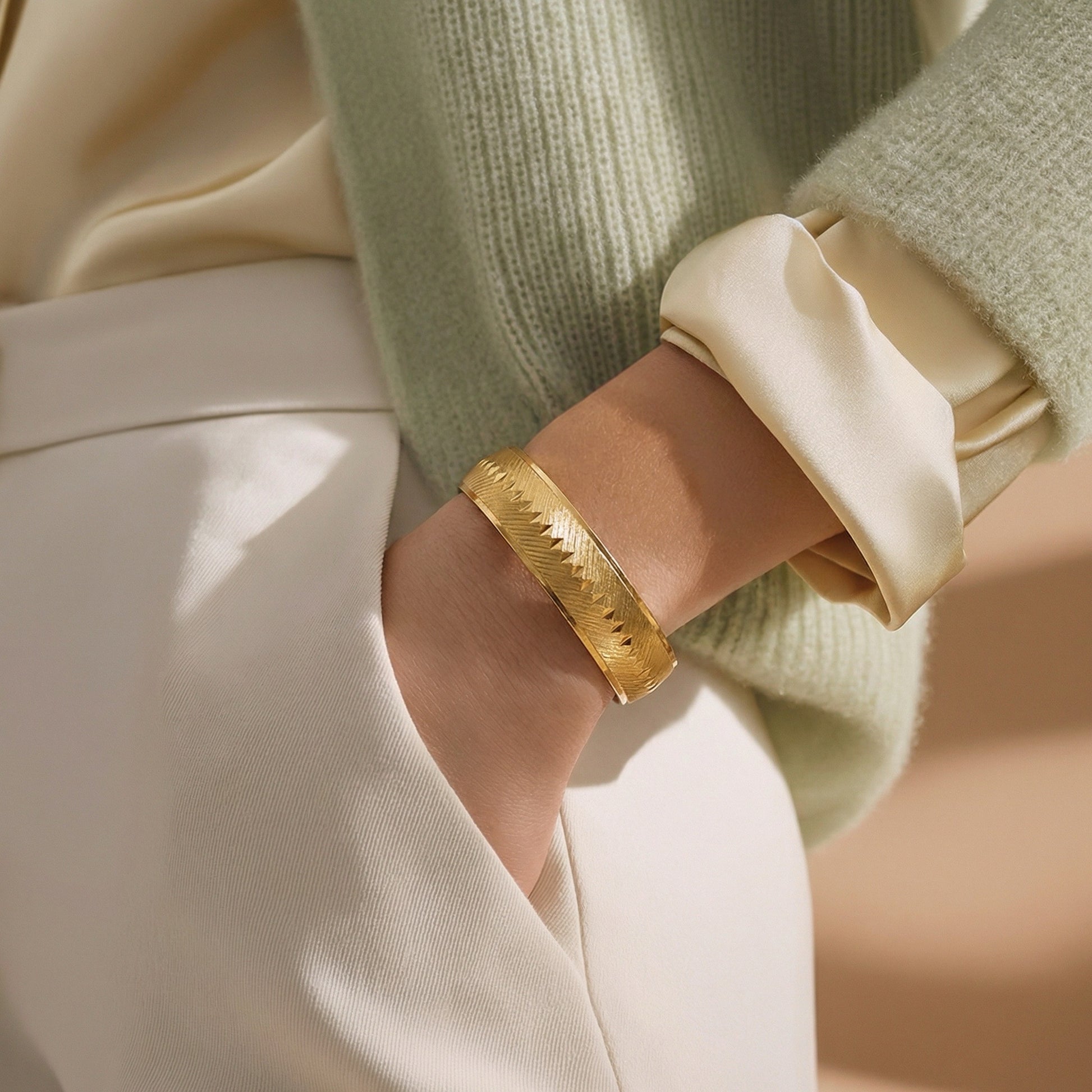 Monet gold textured bangle worn on wrist