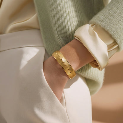 Monet gold textured bangle worn on wrist