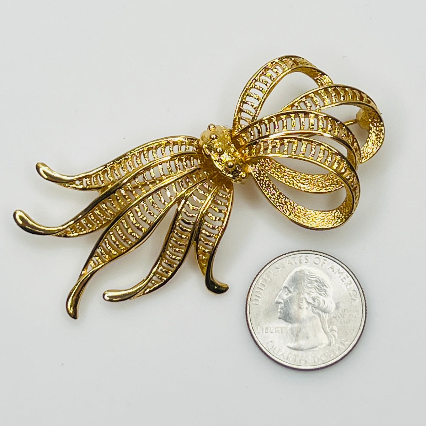Vintage Monet goldtone ribbon brooch with sculptural bow design