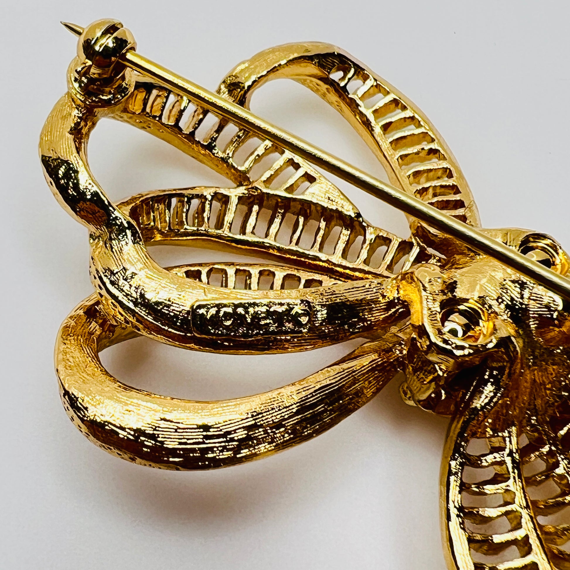 Back of Monet brooch showing maker's mark and secure pin clasp