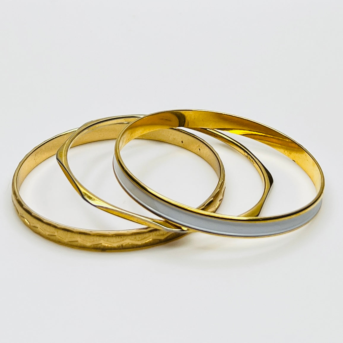 Monet and Napier gold tone bangle set with white enamel