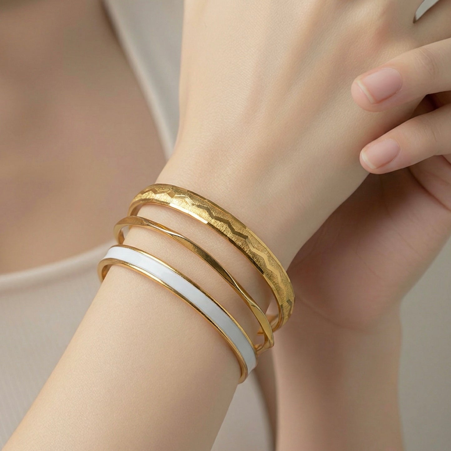 1980s gold designer bangles stacked on wrist