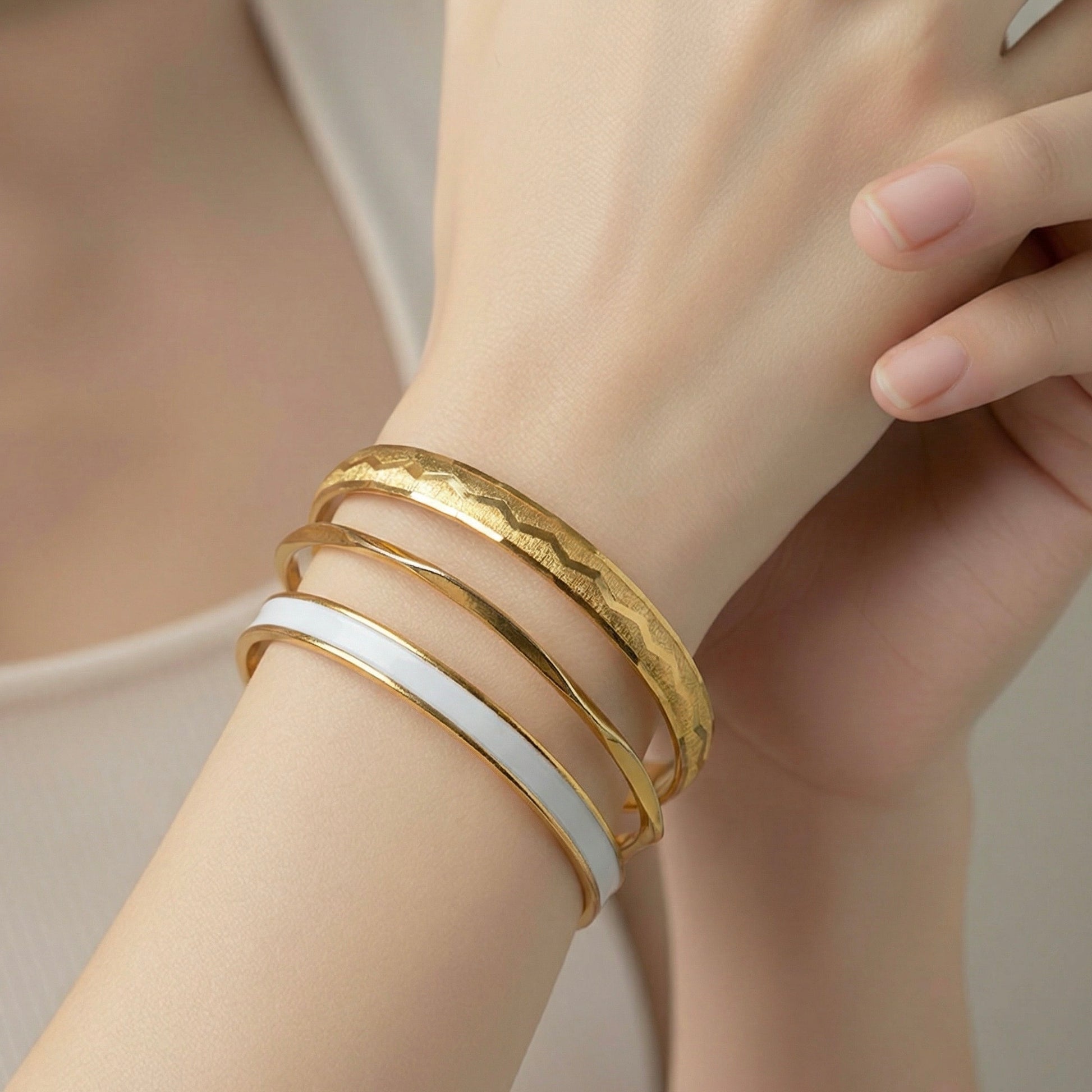1980s gold designer bangles stacked on wrist