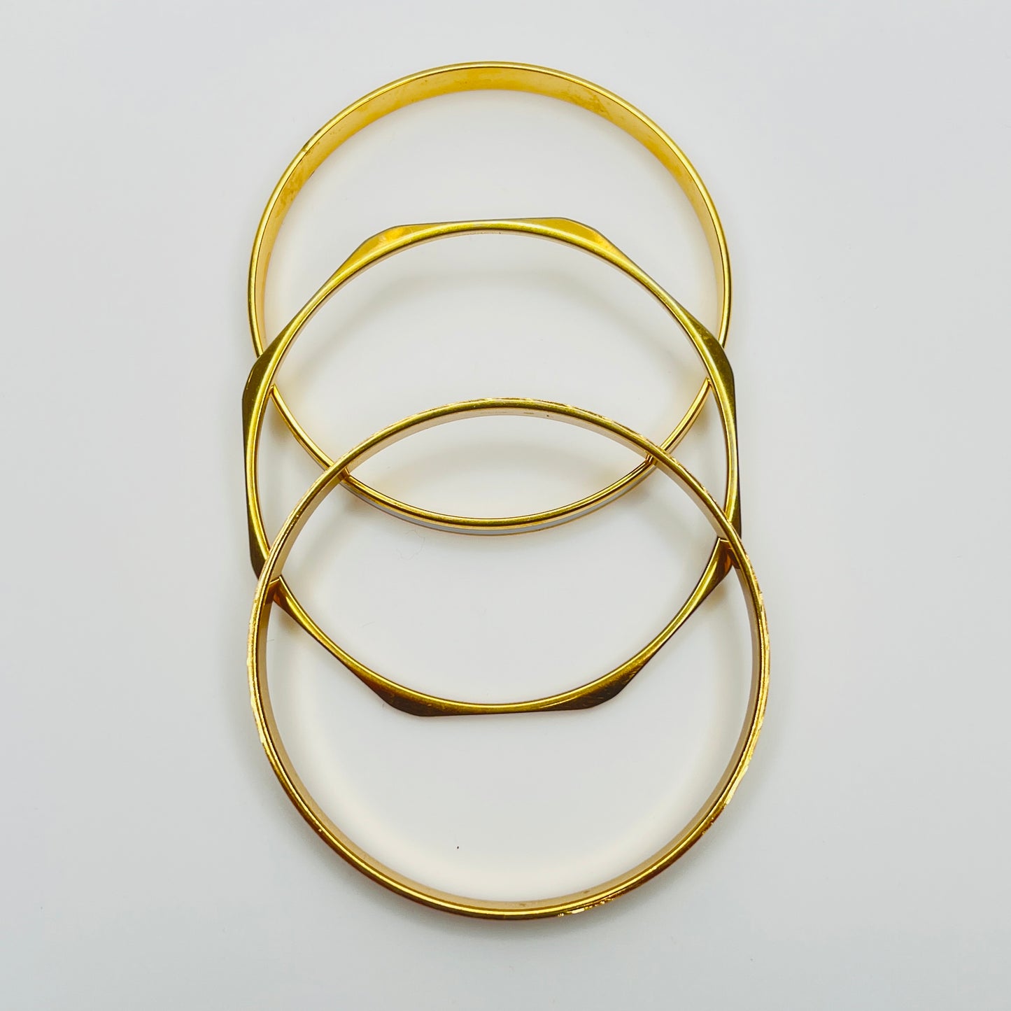 Monet and Napier gold tone bangle set with white enamel