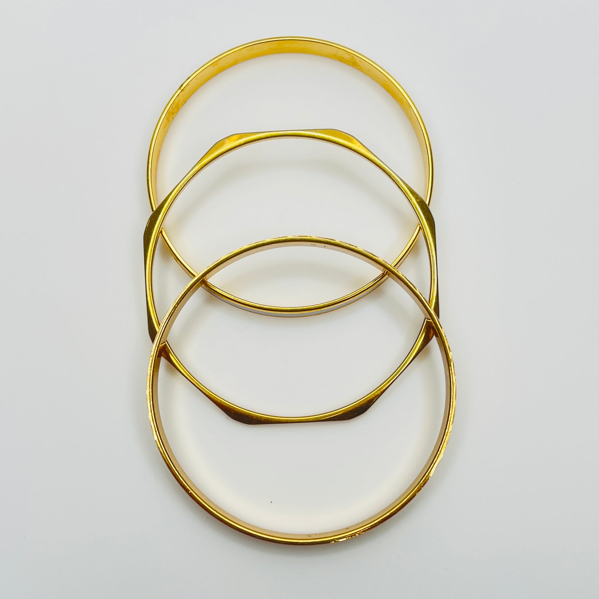 Monet and Napier gold tone bangle set with white enamel