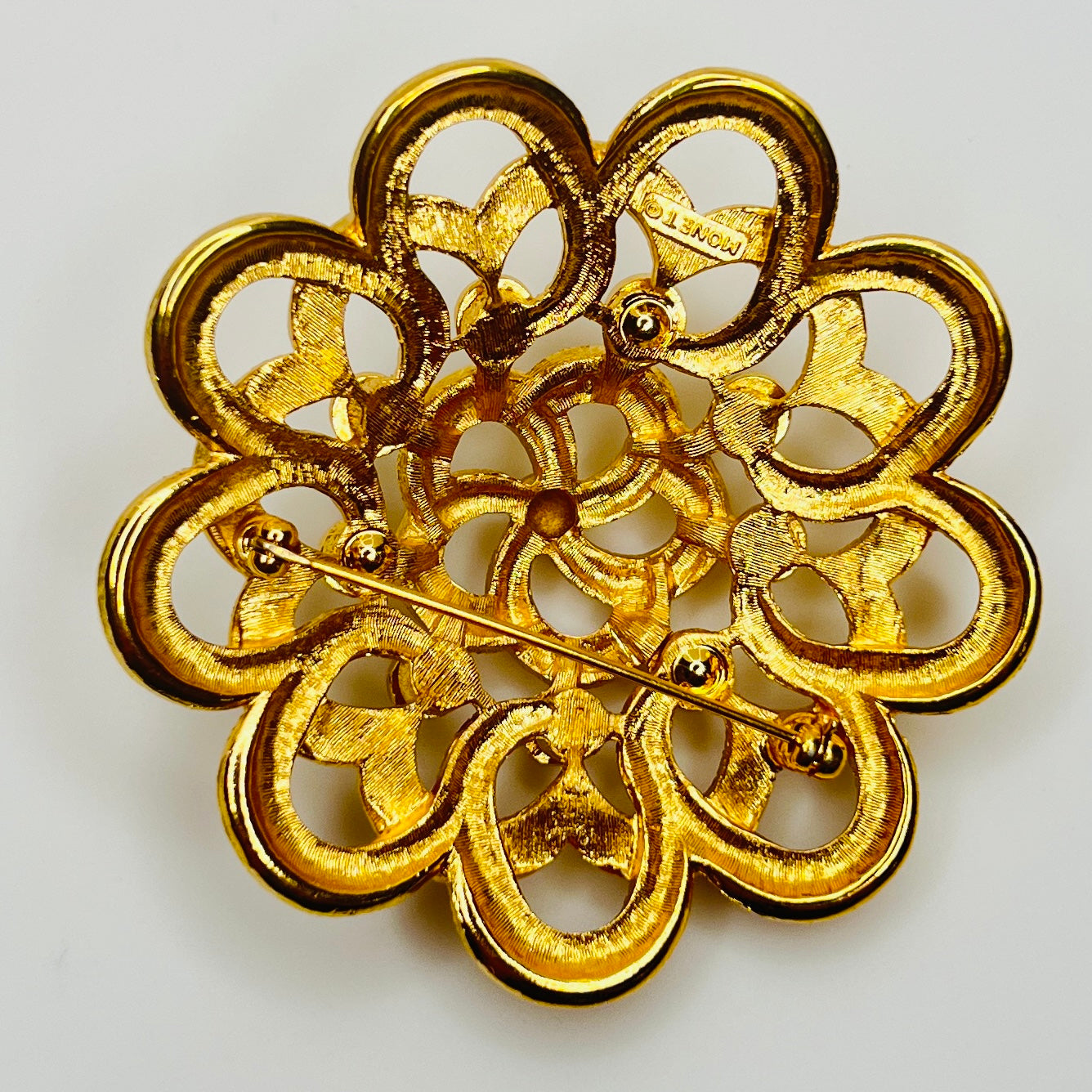 Back of signed Monet mid century gold brooch