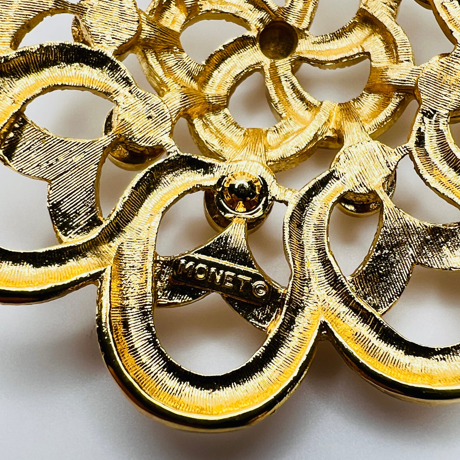 Back of signed Monet mid century gold brooch