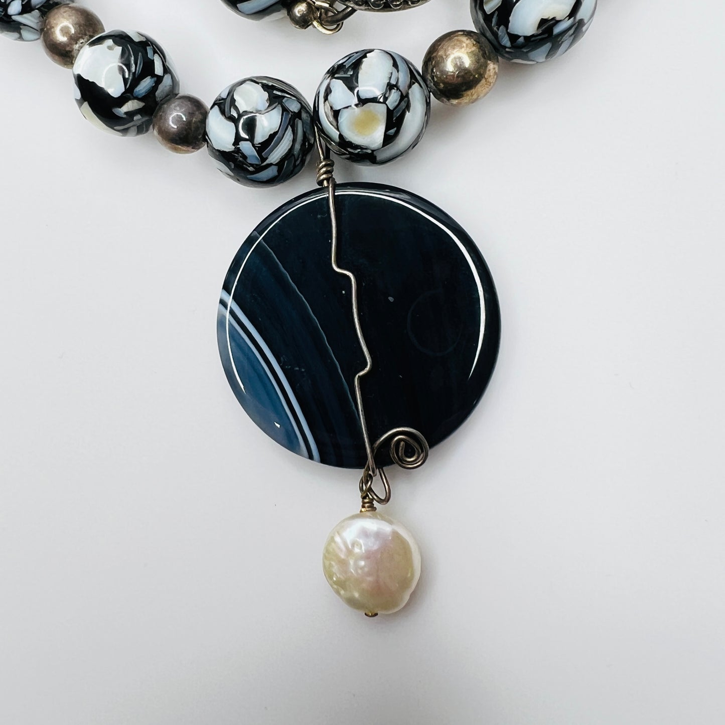 Close-up of wire-wrapped pendant with cultured pearl