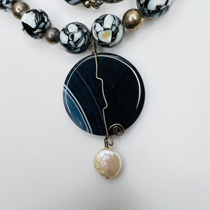 Close-up of wire-wrapped pendant with cultured pearl
