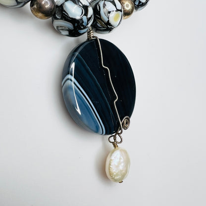 Close-up of wire-wrapped pendant with cultured pearl