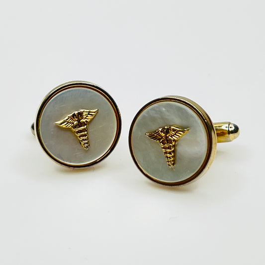Vintage 1970s gold-tone cufflinks with mother of pearl and caduceus insignia