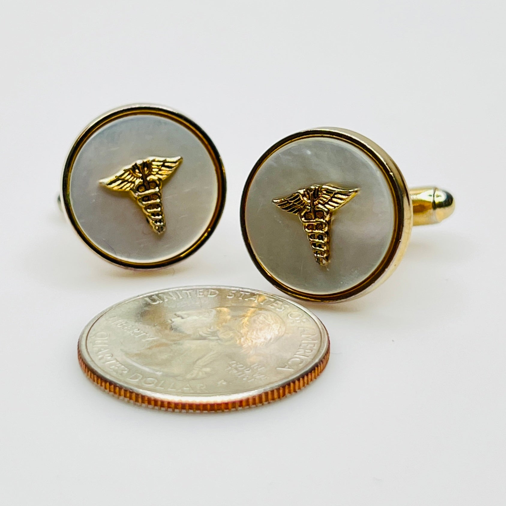 Vintage 1970s gold-tone cufflinks with mother of pearl and caduceus insignia