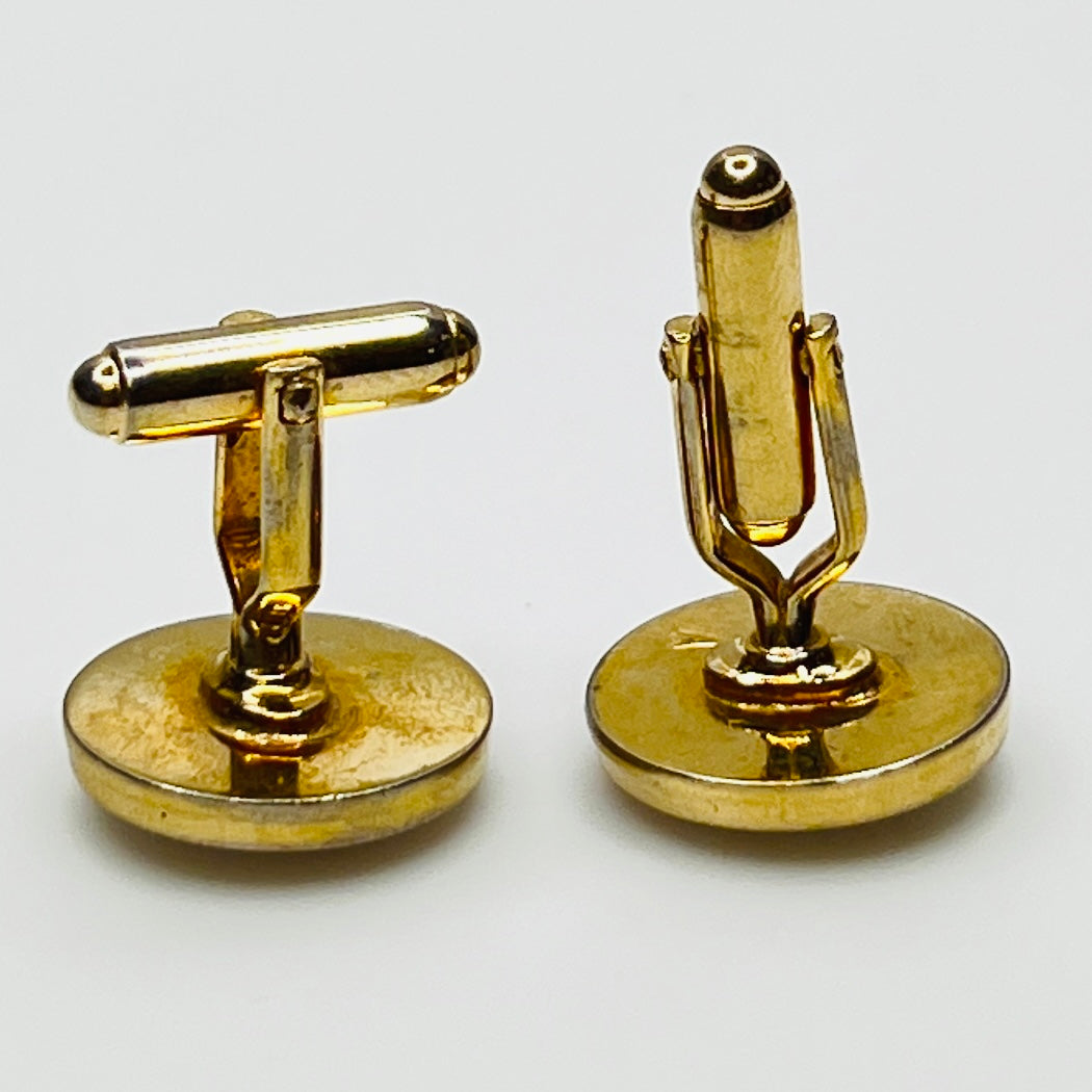 Side view of medical cufflinks showing gold-tone swivel backs