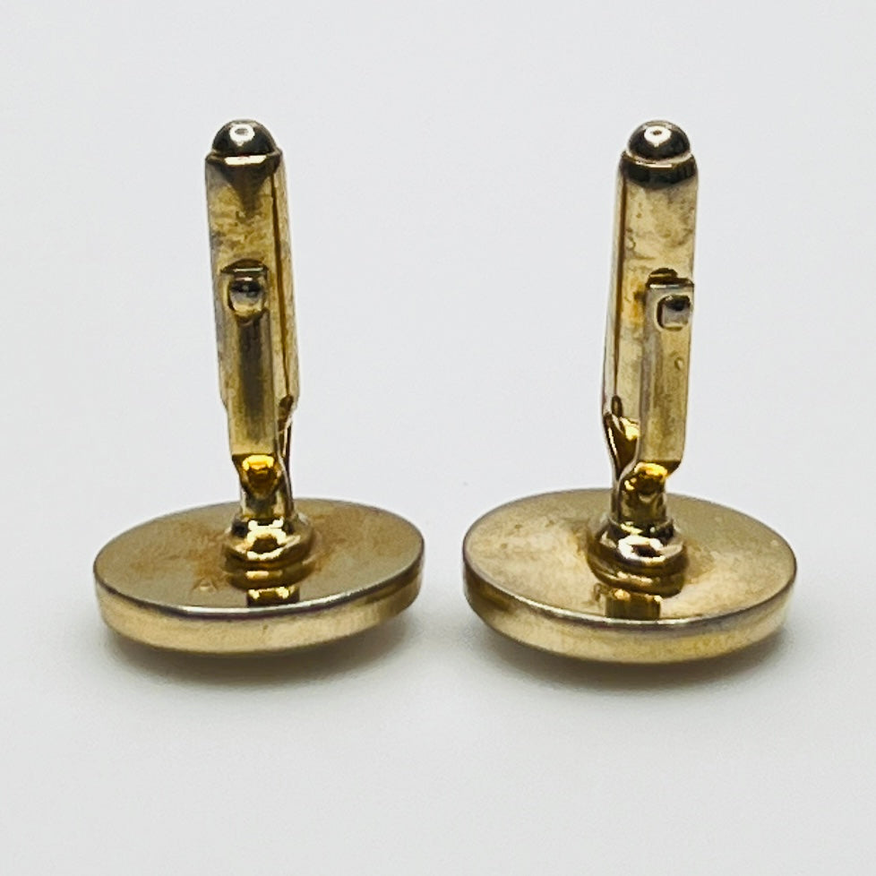 Side view of medical cufflinks showing gold-tone swivel backs