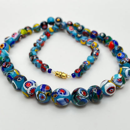 Close-up of floral mosaic glass beads in vibrant colors