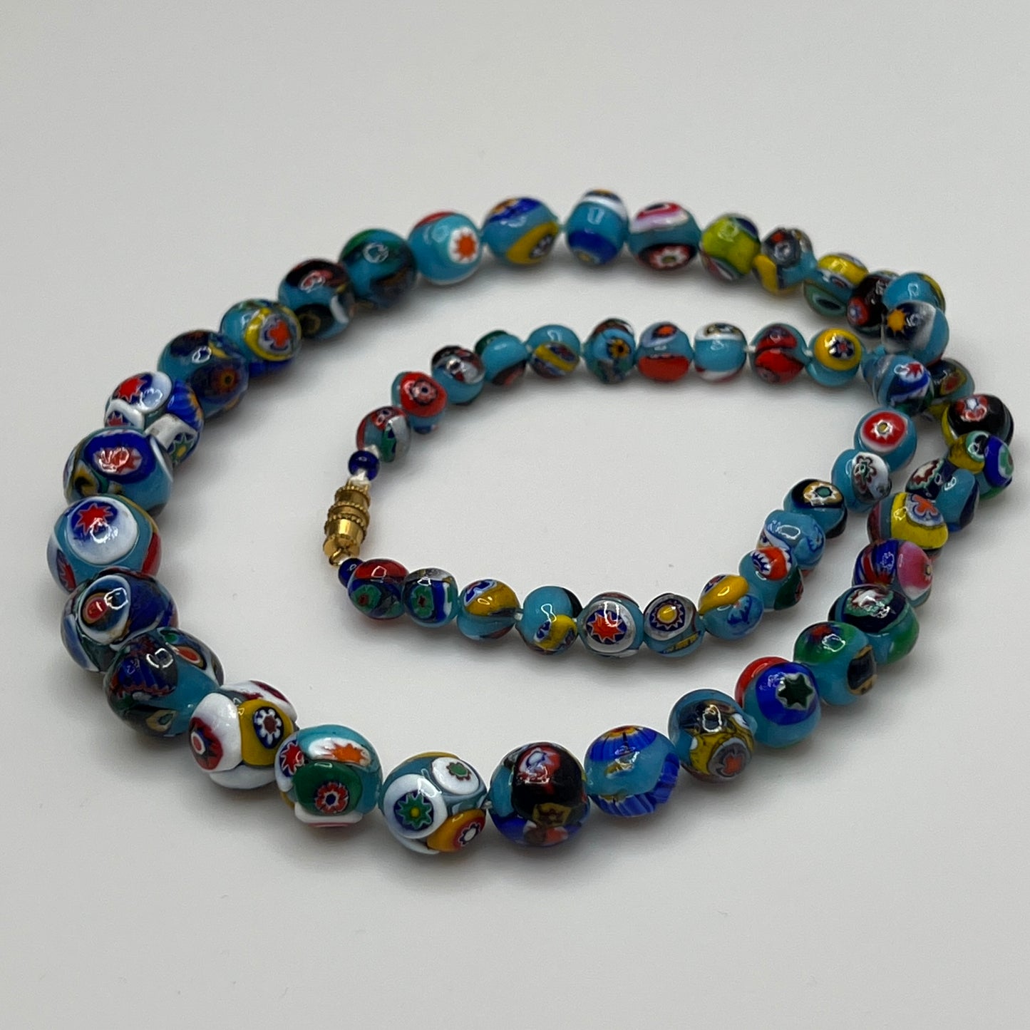 Close-up of floral mosaic glass beads in vibrant colors