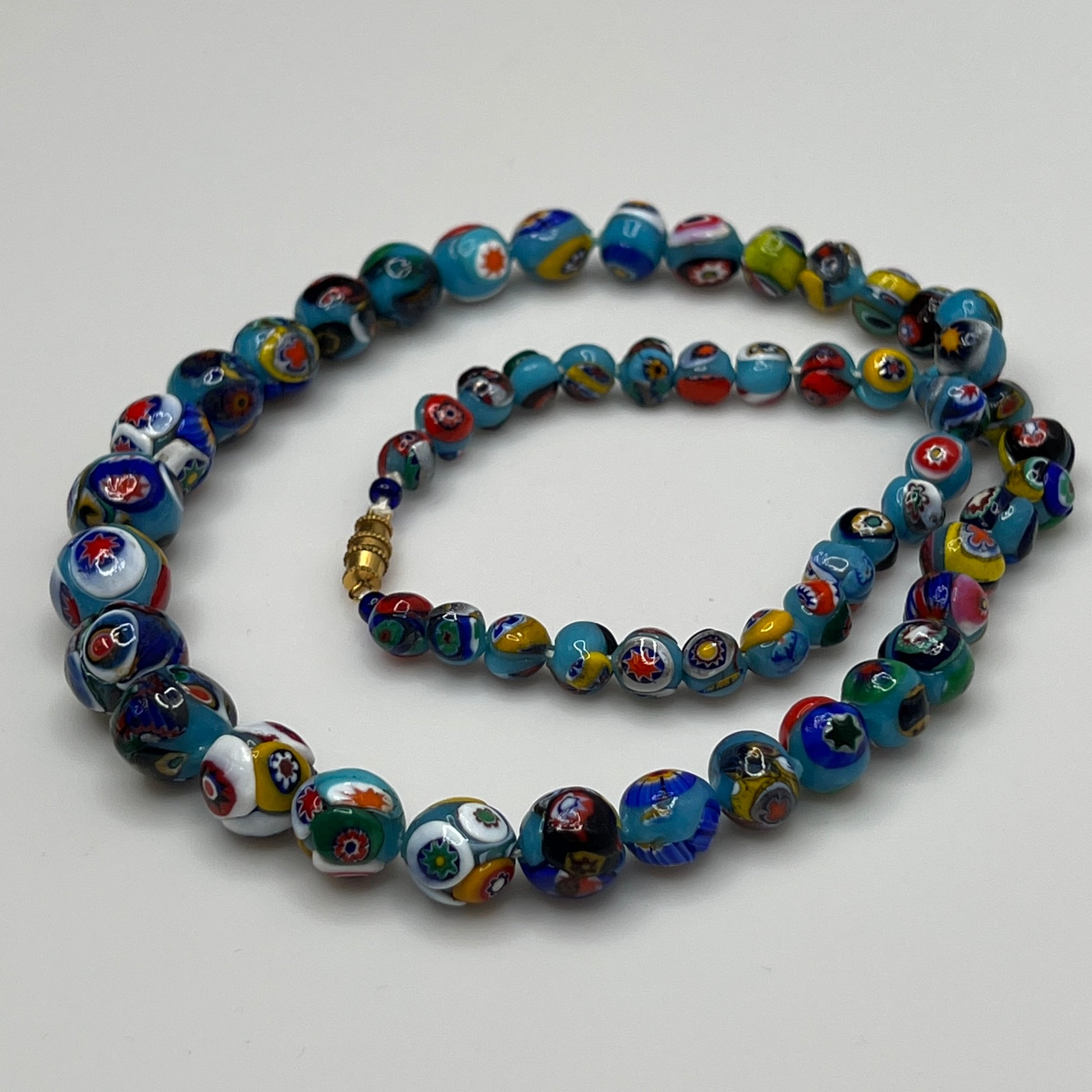 Close-up of floral mosaic glass beads in vibrant colors