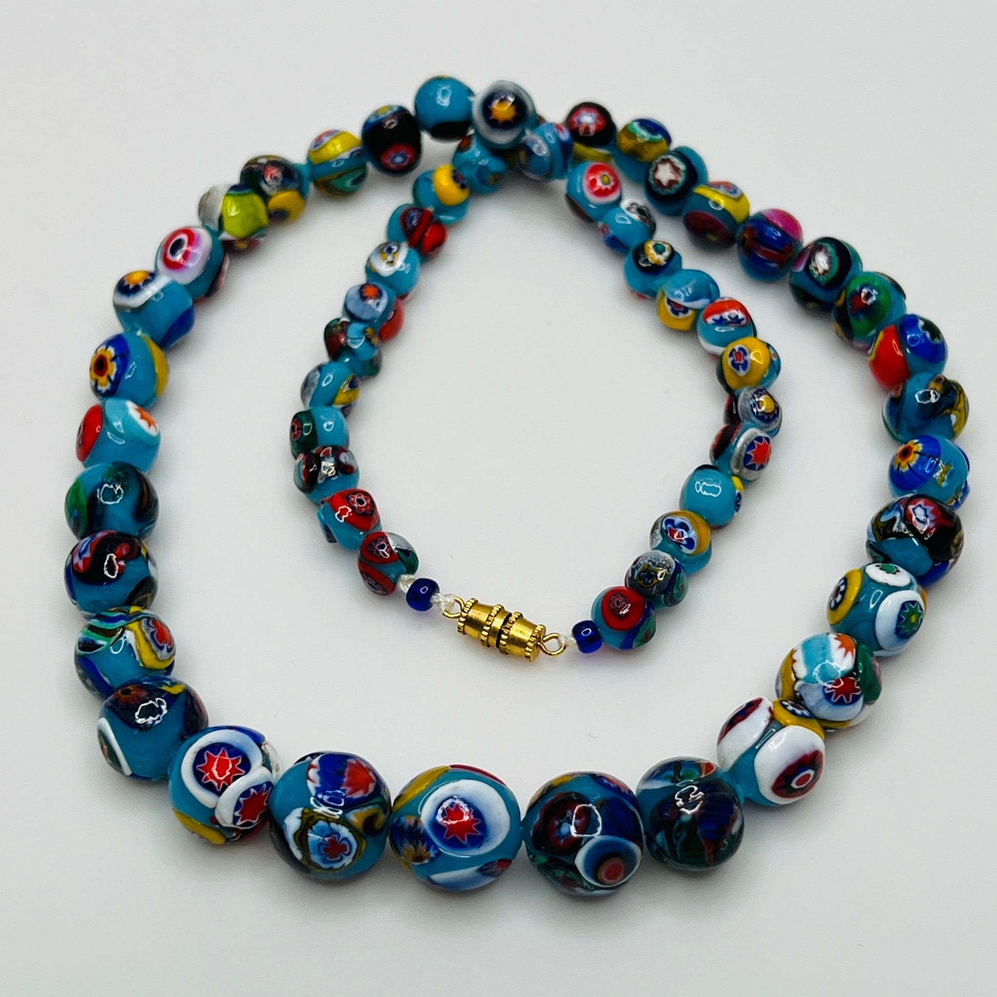 Close-up of floral mosaic glass beads in vibrant colors