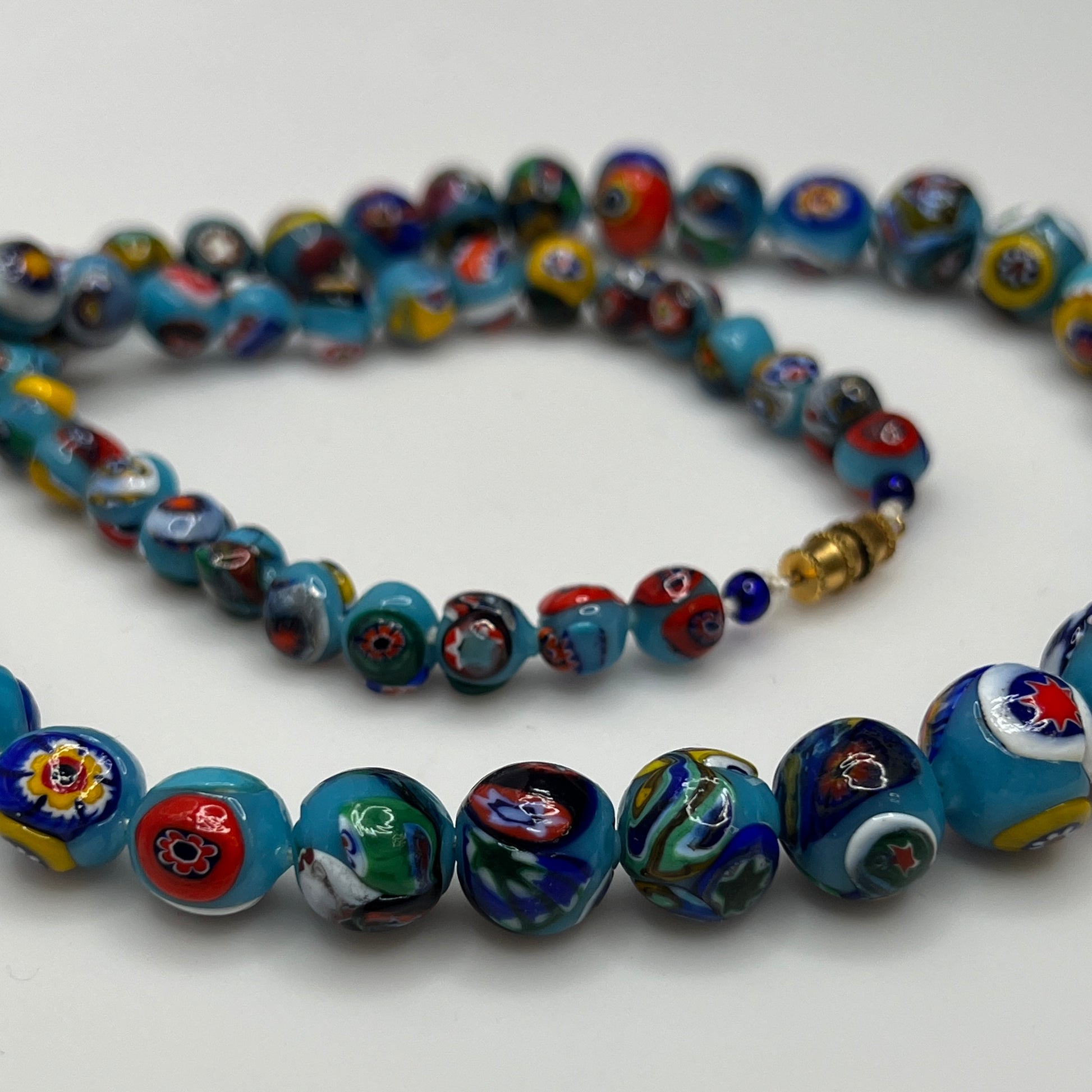 Close-up of floral mosaic glass beads in vibrant colors