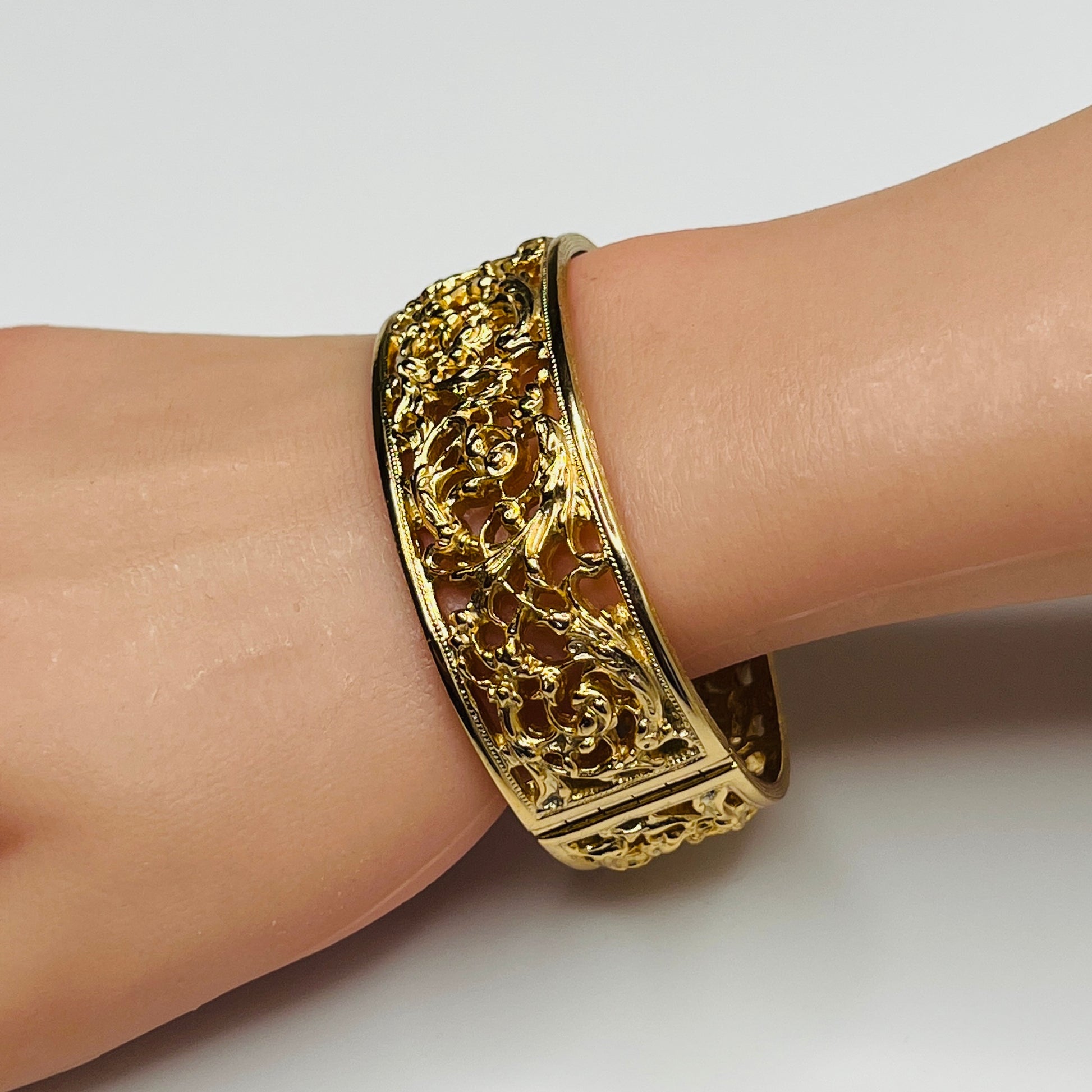 Close-up of ornate floral openwork design on vintage Napier bracelet