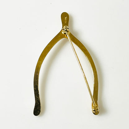 Reverse of gold-tone Napier wishbone brooch showing the long pin and clasp.