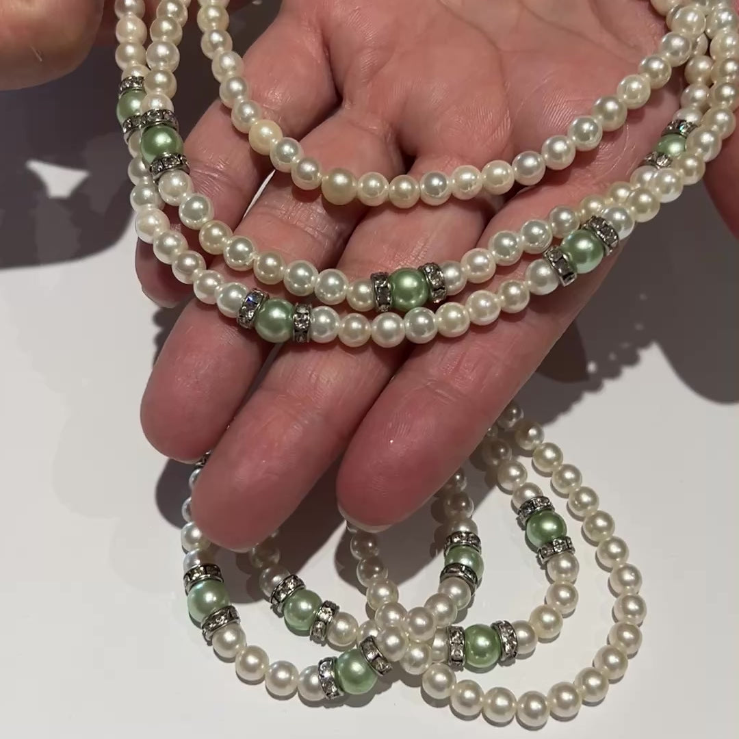 Three-strand faux pearl necklace and bracelet set with sage green pearls and rhinestone spacers.
